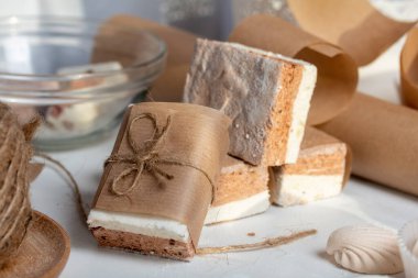 Porsiyon marşmelov, kakao ve kızılcık. Kağıda sarılmış ve iple bağlanmış. İki katmanlı zephyr.