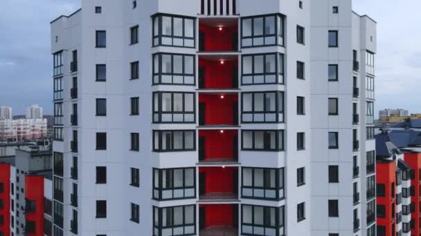 The drone flies away from the new home. Multi-storey buildings in the new city block. The construction site is visible. — Stock Video