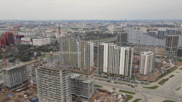 Flight over the construction site. High-rise buildings under construction and construction cranes are visible. Aerial photography — Stock Video