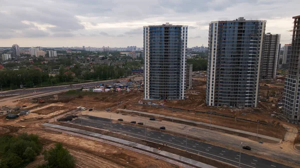 Modern urban development. Construction site with multi-storey buildings under construction. Construction work is underway. Aerial photography.