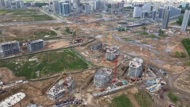 Modern urban development. Construction site with multi-storey buildings under construction. Construction work is underway. Aerial photography. — Stock Video