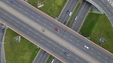 Çok katlı bir kavşağın üzerinden uçmak. Kamera devre dışı. Aşağıda toplu taşıma araçlarının hareketini görebilirsiniz. Şehir havası video çekimi.