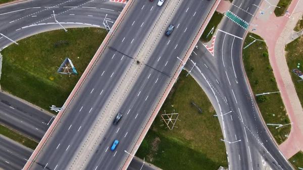 Flight over a multi-level road junction. Public transport is visible. City aerial photography.