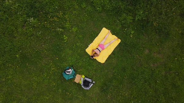 Kobieta Opala Się Zielonej Łące Leżał Brzuchu Żółtym Dywanie Fotografia — Zdjęcie stockowe