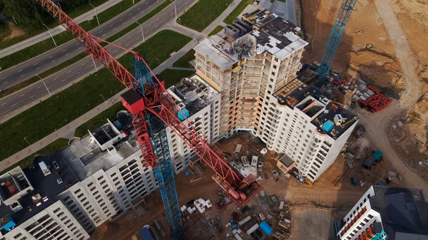 Aerial view of the new urban development. New houses are being built. The cranes are visible.