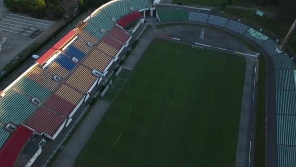 Fotbalový stadion v městském parku. Zelené pole a stojany jsou viditelné, malované v různých barvách. Záběr zblízka. Letecká fotografie. — Stock video