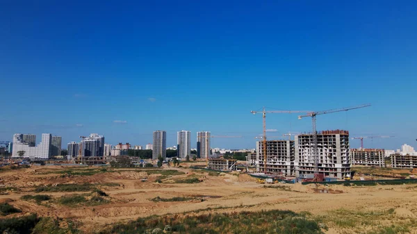 Modern urban development. Construction site with multi-storey buildings under construction. Construction of a new city block. Aerial photography.