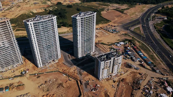 Modern urban development. Construction site with multi-storey buildings under construction. Construction of a new city block. Aerial photography.