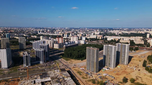 Modern urban development. Construction site with multi-storey buildings under construction. Construction of a new city block. Aerial photography.