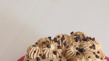 Carrot cake decorated with chocolate drops. Close-up shot.