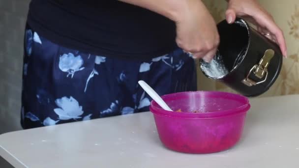 Cooking carrot cake. A woman sprinkles flour on a dough dish. Close-up shot. — Video Stock