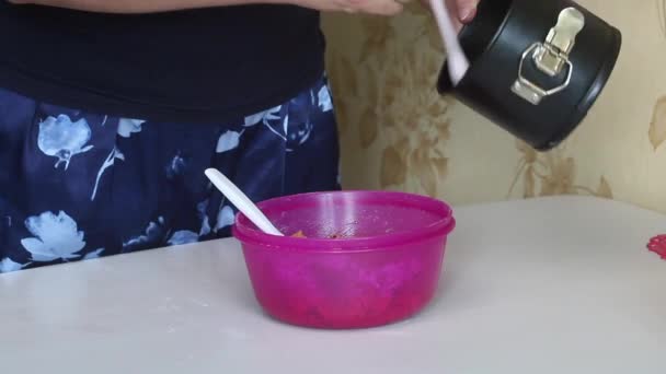 Cooking carrot cake. A woman lubricates a dough mold. Close-up shot. — Video Stock