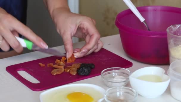Cocinar pastel de zanahoria. La mujer corta frutas secas. Primer plano de disparo. — Vídeos de Stock