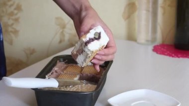 A woman demonstrates homemade ice cream. Ice cream with cream, biscuits and bread. Close-up shot.