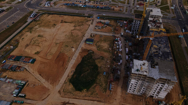 Construction site for a new city block. Construction work is underway. Aerial photography.