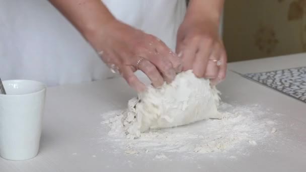 A woman kneads dough for dumplings. On the surface of the table. Cooking dumplings with potatoes and minced meat. Close-up shot. — Stock Video