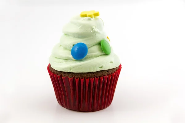 Cupcake with green cream isolated on white background — Stock Photo, Image