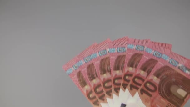 Hands in white gloves hold a fan of 10 euro bills and ask for cash — Stock Video