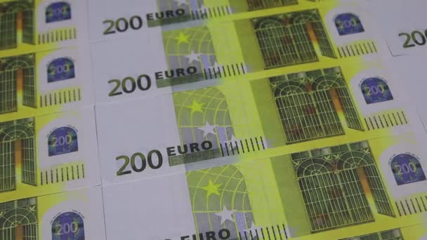 A hand in a white glove puts heart-shaped stickers on 200 euro banknotes — Wideo stockowe