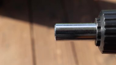 The screwdriver head is slowly inserted into the black screwdriver mount