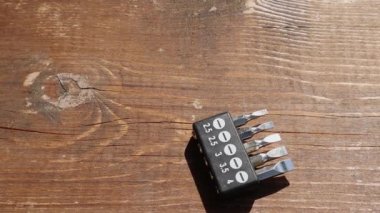 Sets of heads milking screwdrivers take turns falling on the brown wooden floor