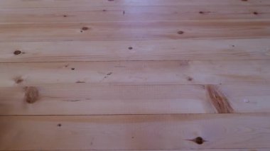 A trolley on wheels with a lighting device rolls on the wooden floor