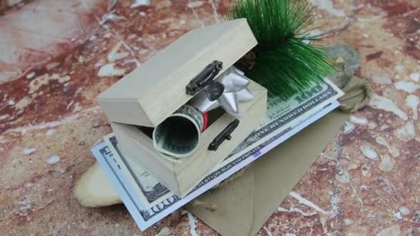 Karácsonyi ajándék egy tekercs 100 dolláros bankjegy bemutatott egy kis fadobozban — Stock videók