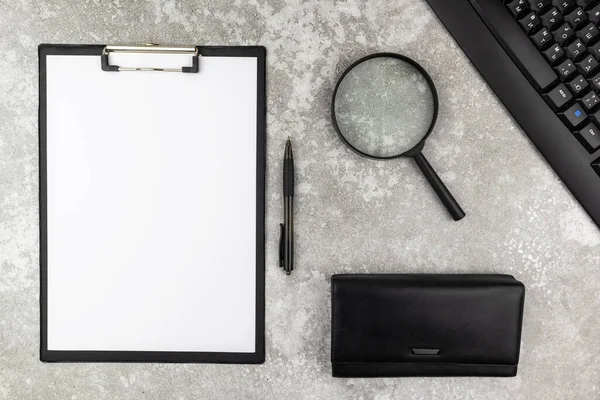 Office workstation or business background with magnifying glass. Flat lay