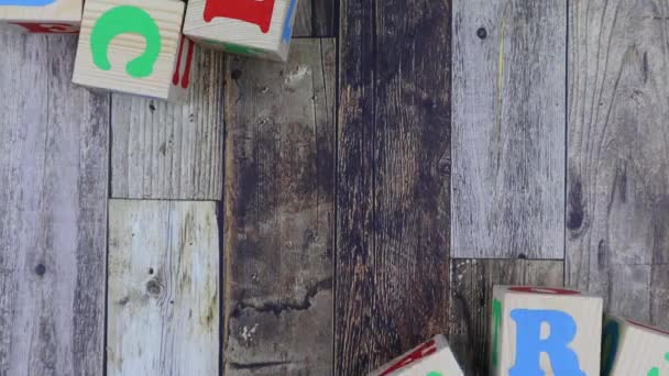 Colourful alphabet letters on wooden cubes with word - Happy. Stop motion — Stock Video