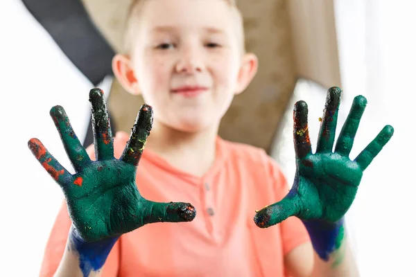 boy paint with hands drawing lesson at school