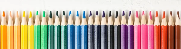 Colored pencils in row on a white background — Stock Photo, Image