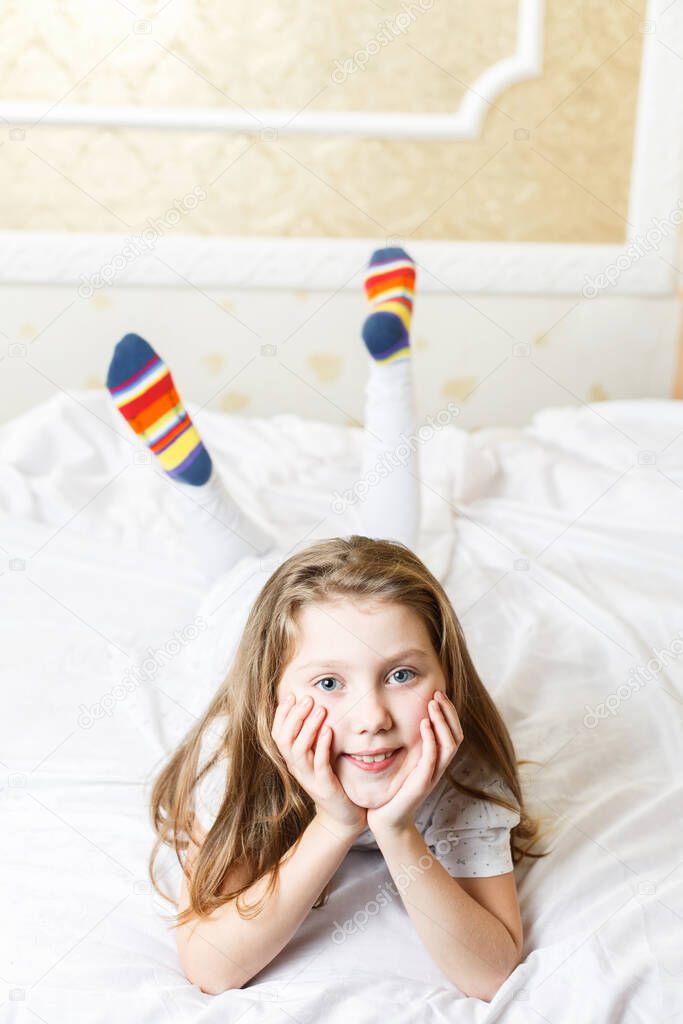 little girl on the bed good mood and healthy sleep