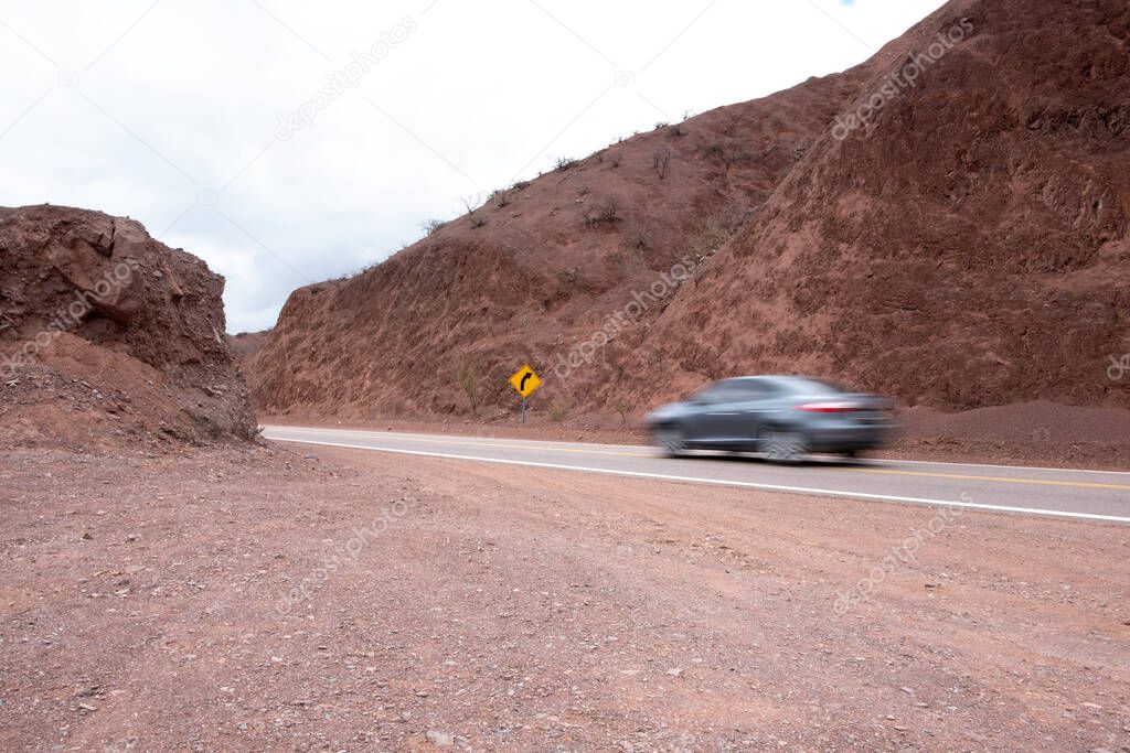 Car driving on desert road, Cafayate, Salta, Argentina