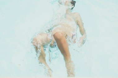 Soyut fotoğraf koleksiyonu. Tanınmaz halde, çocuk bacağı dizleri suyun içinde. Gizemli bir ruh hali. Ağırlıksızlık kavramı, belirsiz gelecek hayatı, bilinmezlikte boğulma, çocukluk sorunları.