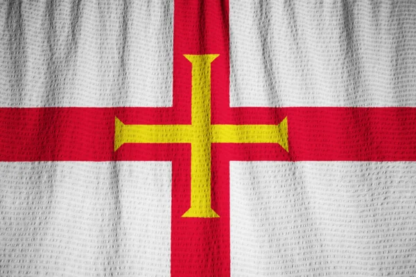 Closeup αναστατωμένα Guernsey σημαία, σημαία του Γκέρνσεϊ πνέει στον άνεμο — Φωτογραφία Αρχείου