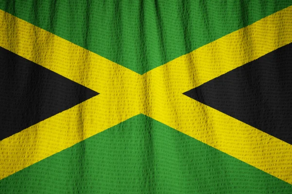 Primer plano de la bandera de Jamaica con volantes, bandera de Jamaica soplando en el viento — Foto de Stock