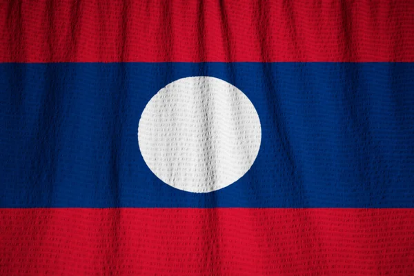Zbliżenie potargane Laos flaga, flaga Laosu wiejący wiatr — Zdjęcie stockowe