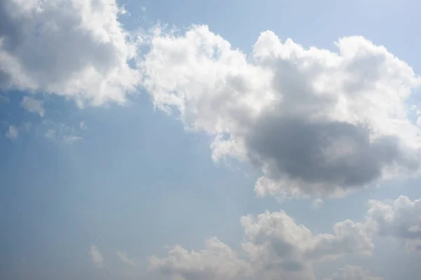 Scattered cloud clusters in a blue sky, blue sky background with white clouds,