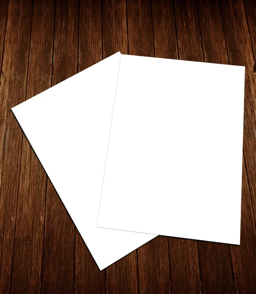 Blank white paper A-4 flyer collection on wooden background — Stock Photo, Image