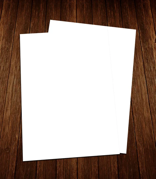 Blank white paper A-4 flyer collection on wooden background — Stock Photo, Image