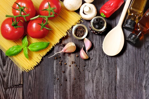 Frisches Gemüse und Nudeln auf dunklem Holz — Stockfoto