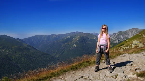 Blond girl on vacation in the mountains. Girl's trekking — Stock Photo, Image