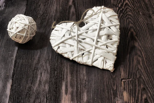 Romantic, white heart and sphere on dark wood — Stock Photo, Image