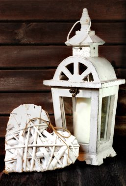 White gardens lantern and rattan heart