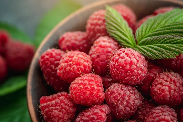 Bowl Fresh Ripe Delicious Raspberries Green Leaves Black Background — Stock Photo, Image