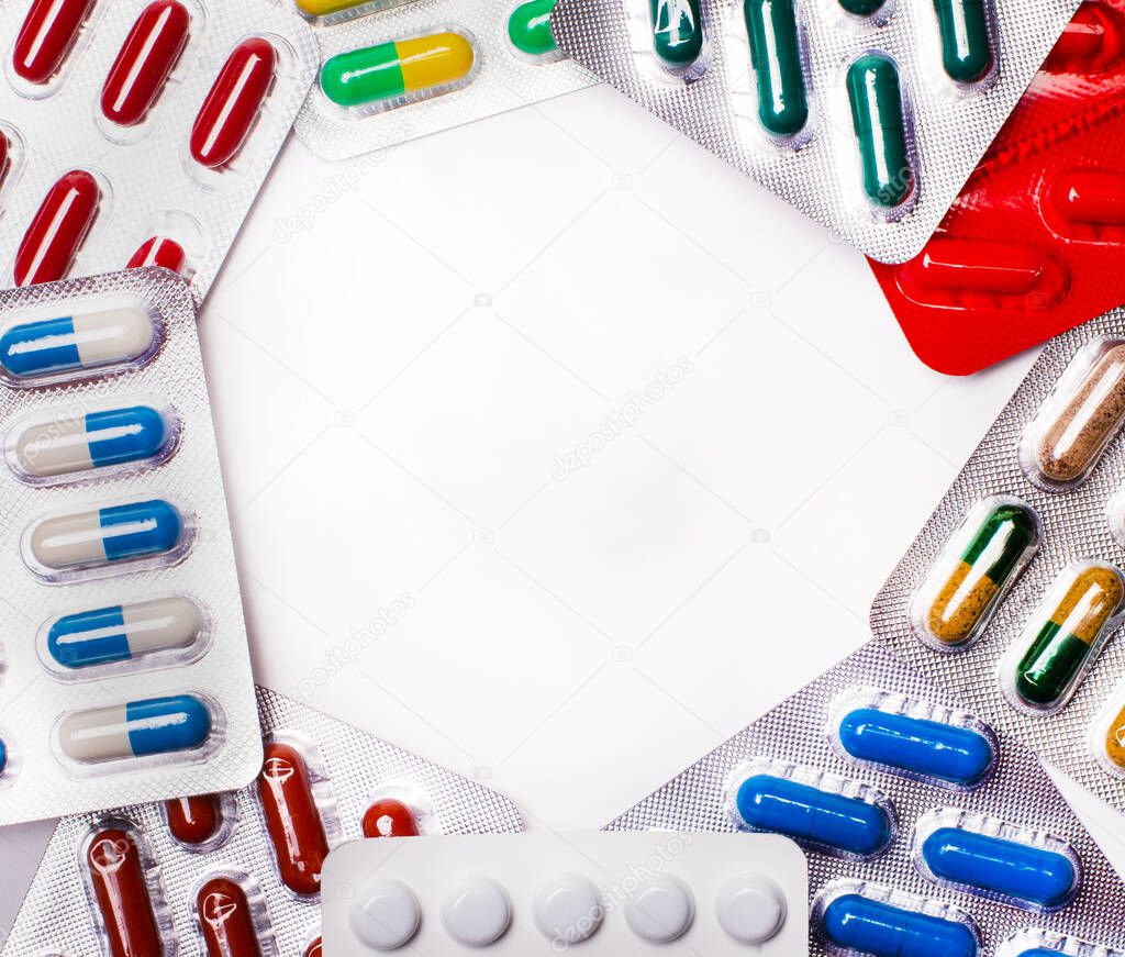 Pharmaceuticals, antibiotics, pills, medicines. Colorful antibacterial pills on a light background. Capsules, tablets, medicines