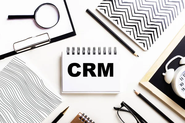 CRM customer relation management abbreviation on blue paper