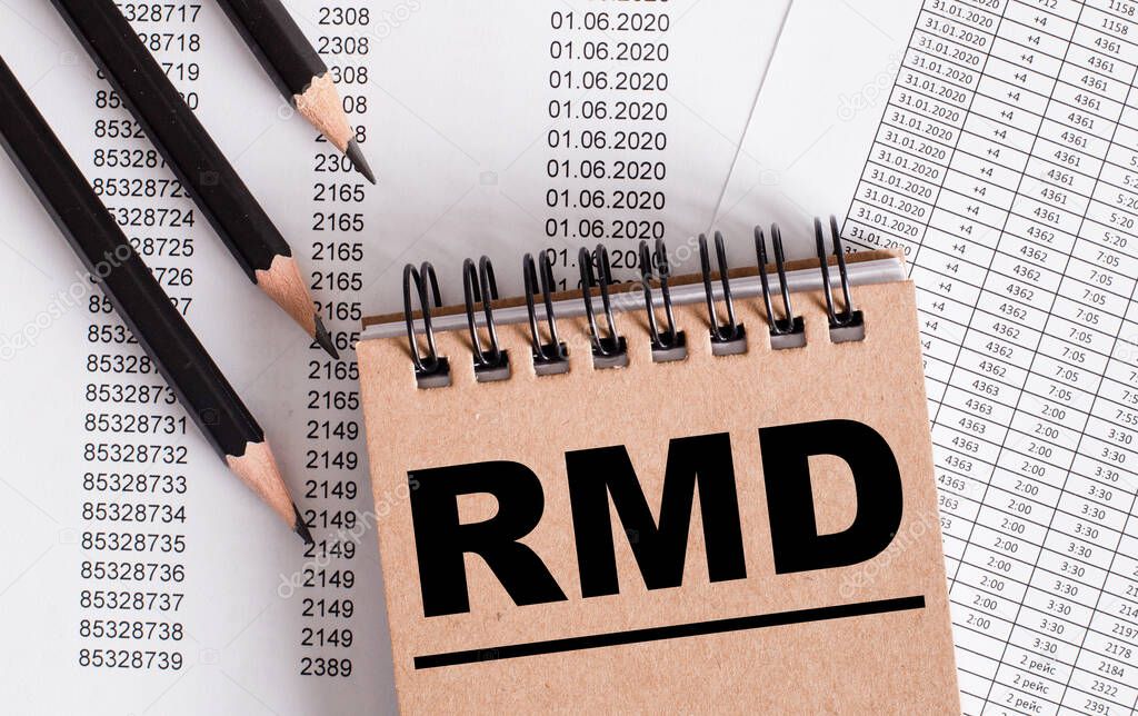 The word RMD is written on the brown notebook. Nearby pencils