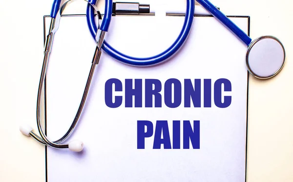 CHRONIC PAIN is written on a white sheet near the stethoscope. Medical concept