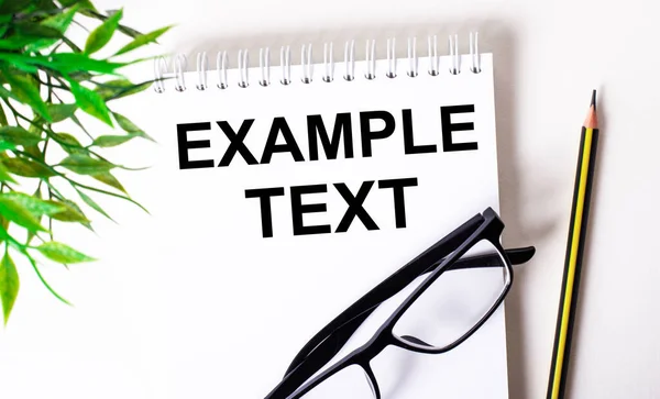 Example Text Written White Notebook Next Pencil Black Framed Glasses — Stock Photo, Image